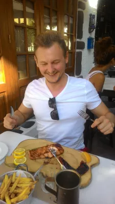September beach weekend in Rhodes, Greece : Koukos - enjoying a tasty salmon fillet