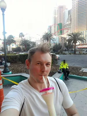 Walking on the best parts of Las Vegas strip up to the neon museum : Enjoying a Vegas Fat Tuesday street drink