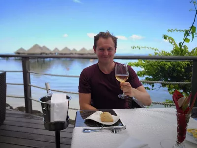 What to eat in Tahiti in the middle of the Pacific ocean? : Enjoying a glass of wine with amazing lunch and view on Tahiti overwater bungalow