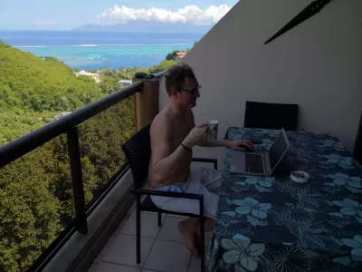 From Corporate to Nomadic: My Decade as a Digital Nomad : Digital nomad working from a balcony in Tahiti, with view on Moorea island in the background